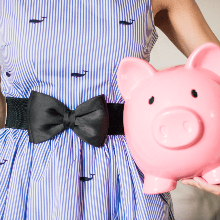 Child holding a pink piggy bank