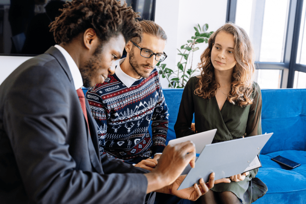 Three people reviewing papers