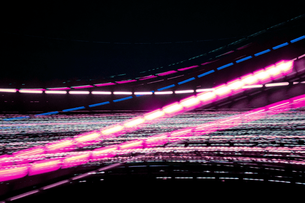 Digital graphic of pink and blue streaks of light