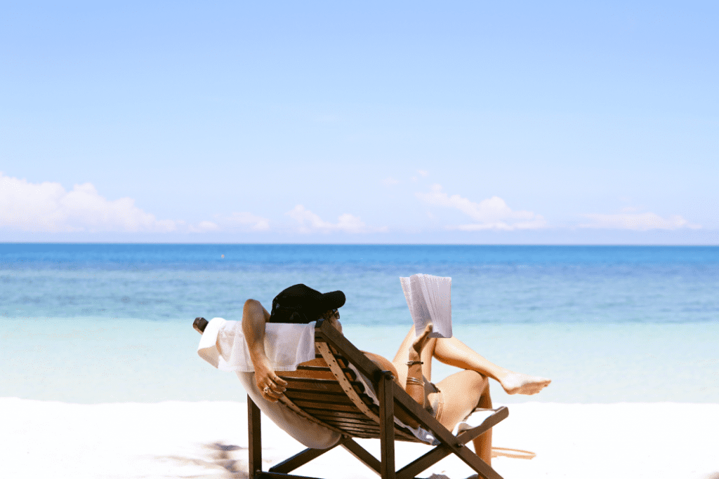 Woman sitting on a beach reading a book