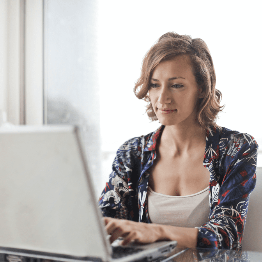 Woman sitting down working on her laptop