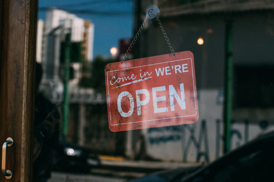 We're open sign hanging in a window