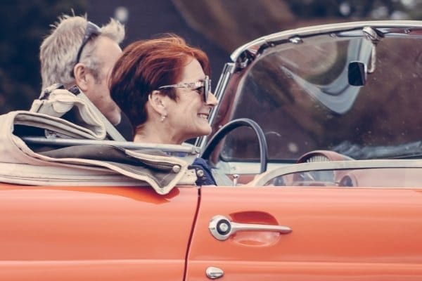 couple riding in a convertible