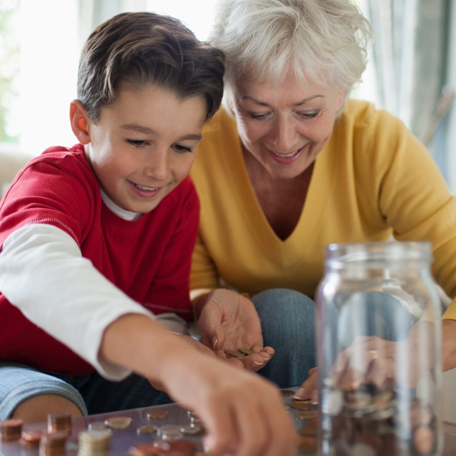 Grandmother and grandson counting coins