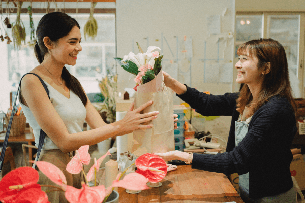 Woman buying flowers from a local shop