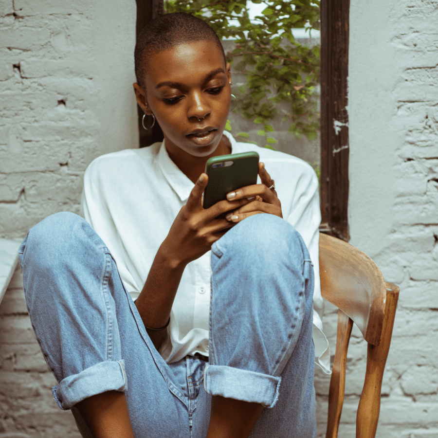 Woman sitting on a chair looking at her cellphone