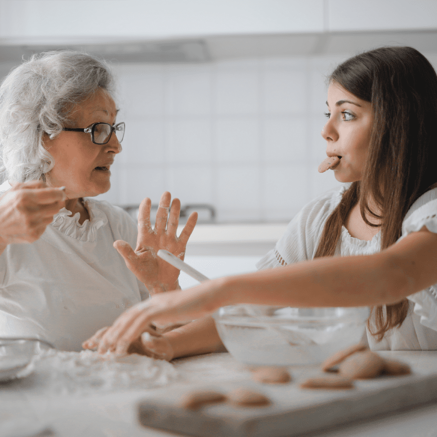 Grandmother and grand-daughter eating cookies