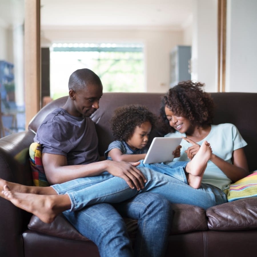 Family sitting on a couch together