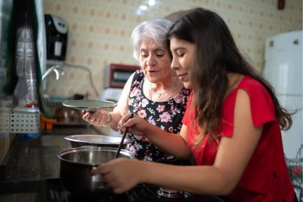 mother and daughter cooking a meal