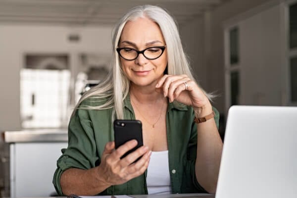 middle-aged woman looking at a cell phone