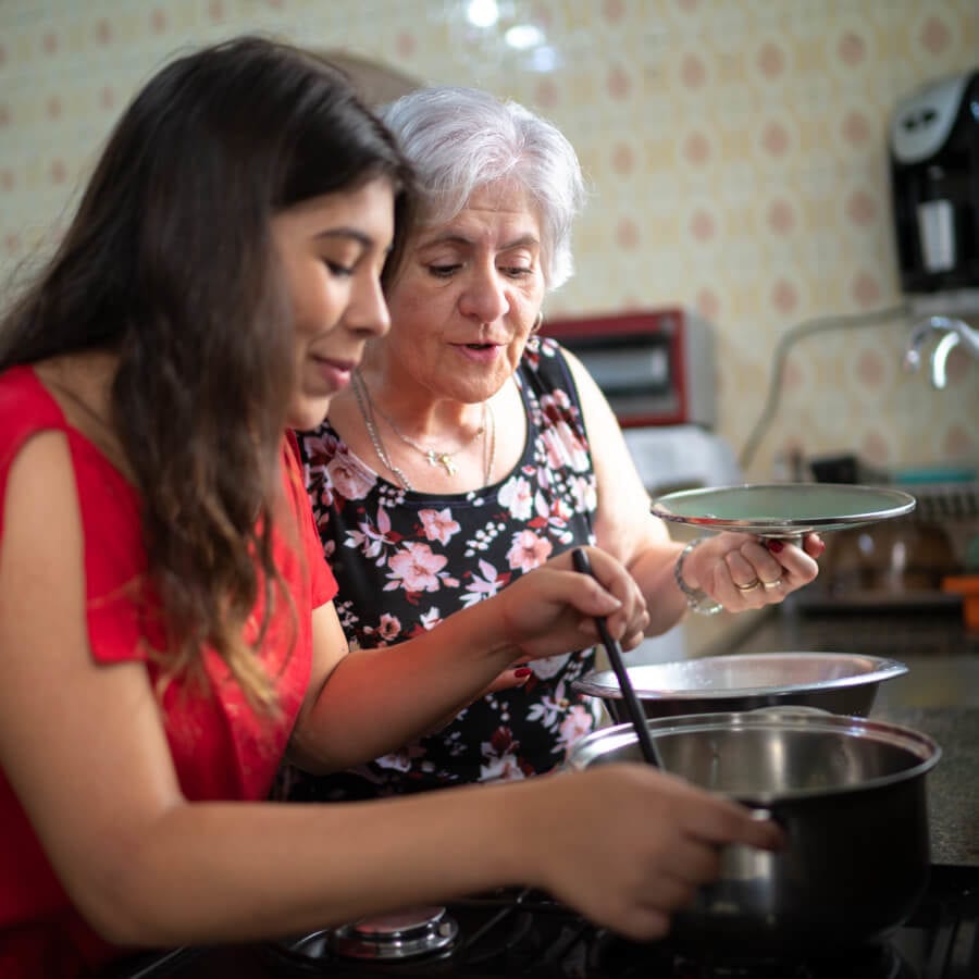 mother and daughter cooking a meal
