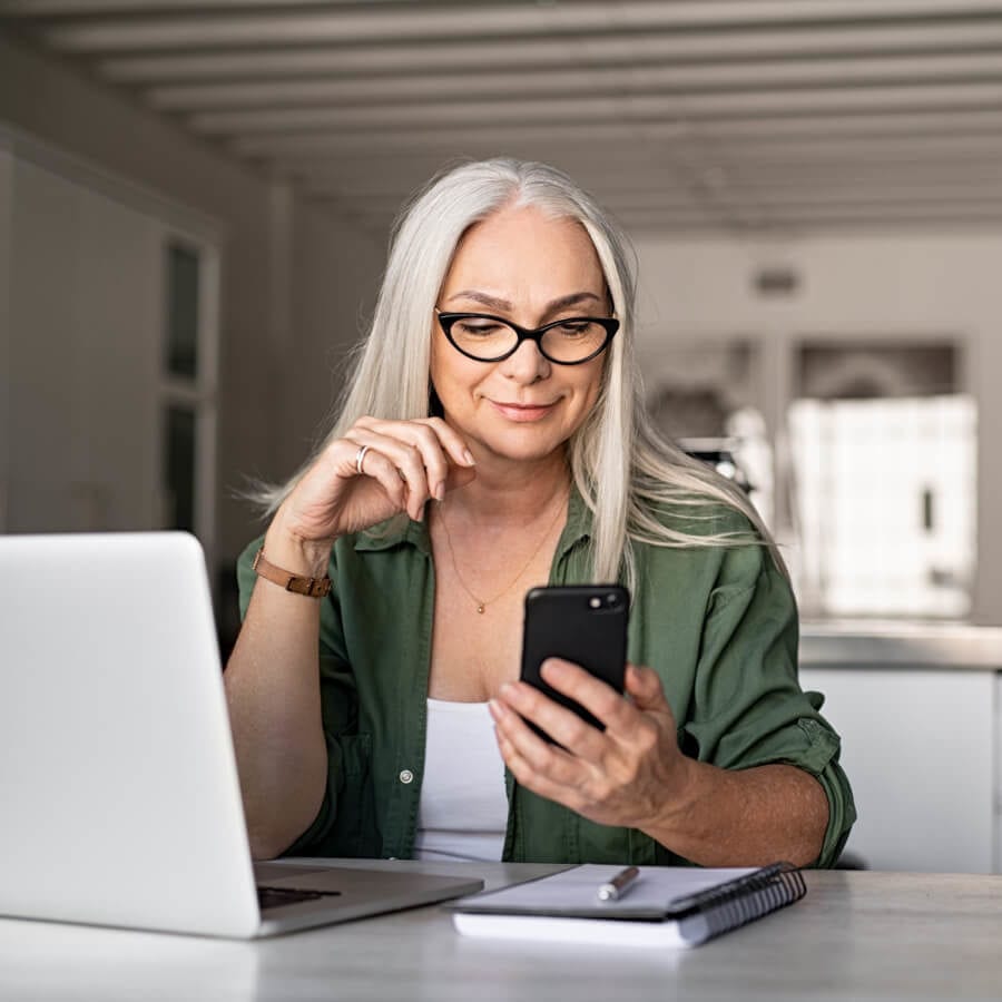 senior woman looking at her cell phone