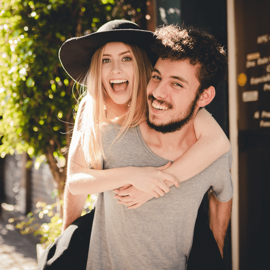 Man giving his girlfriend a piggyback ride