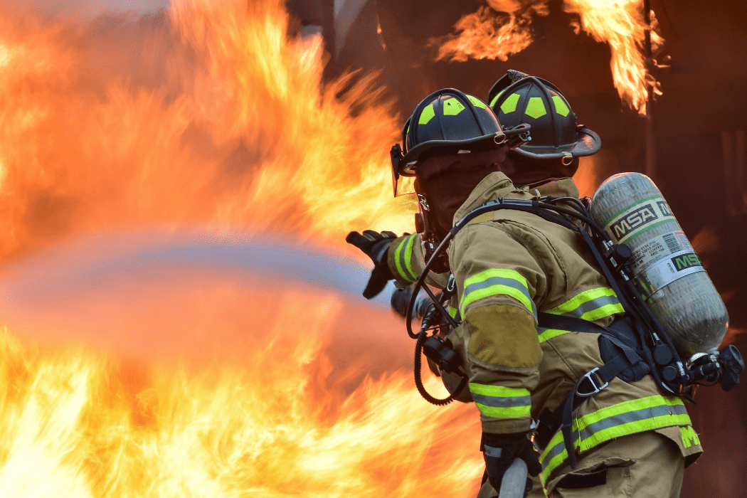 firefighters spraying water on a fire