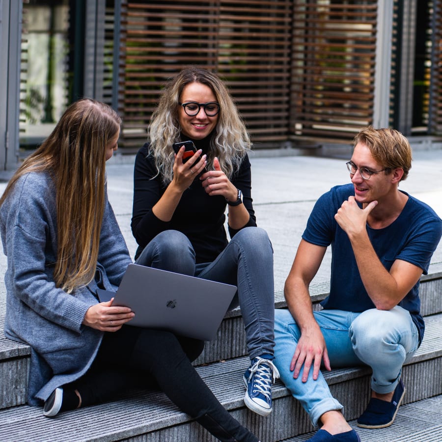 Three friends sitting and talking