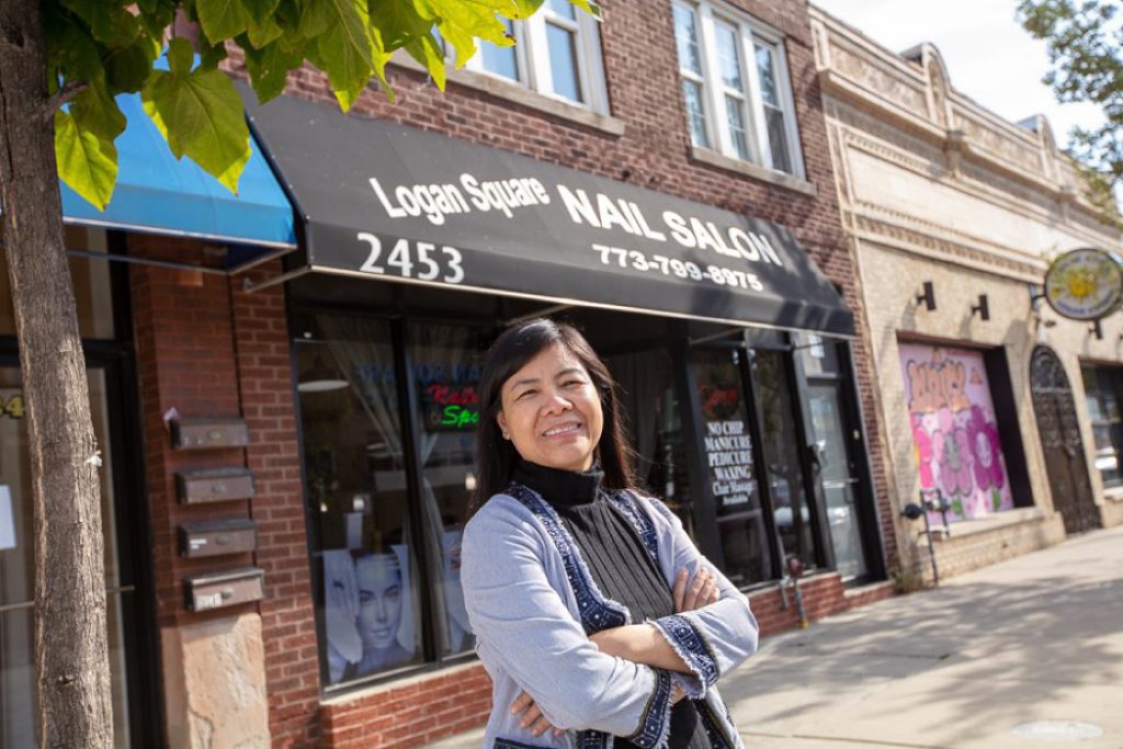 Logan Square business owner in front of nail salon