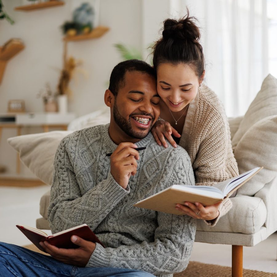 young couple holding a book