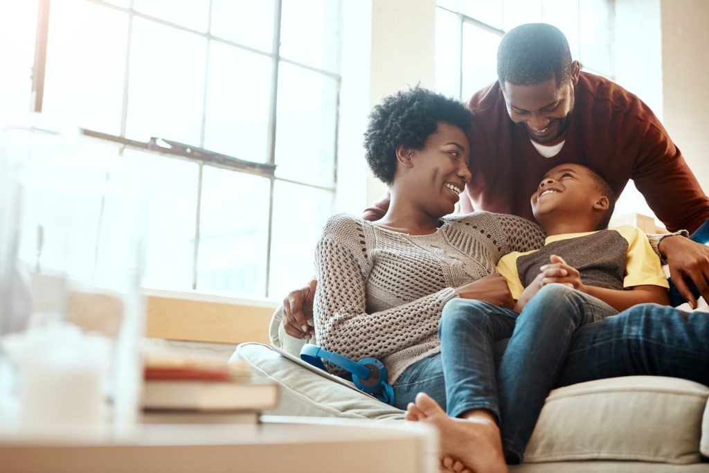 young family cuddling in a chair