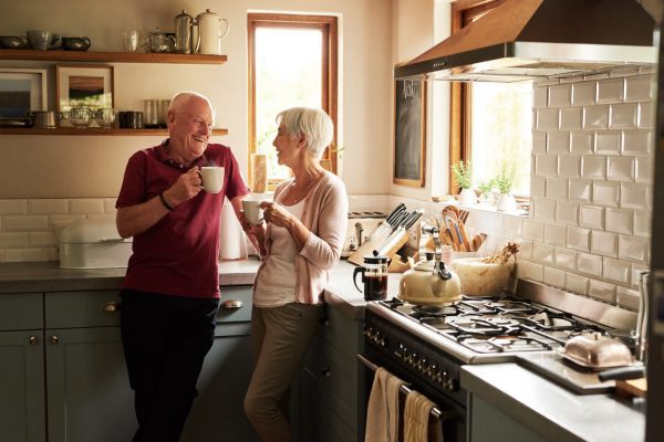 older couple enjoying coffee in their kitchen