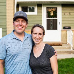 couple standing in front of their new home