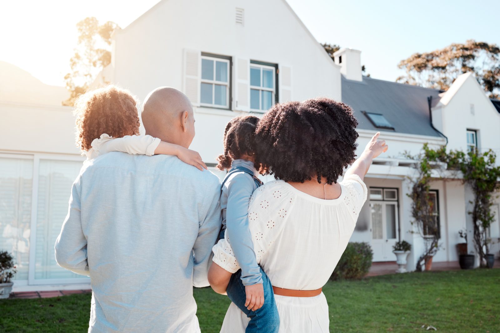 A family is excited about purchasing a new home and they're pointing out the features to the children.