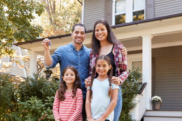 family in front of their home